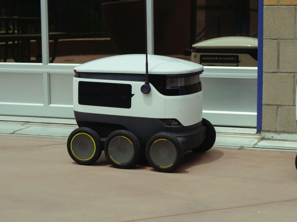 A sleek autonomous delivery robot on city street showcasing innovation.